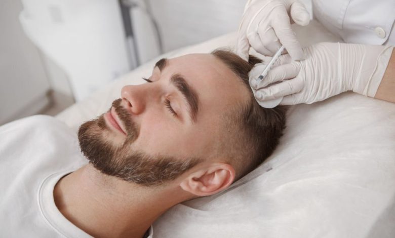 Young man with hairloss problem receiving injections in scalp by trichology doctor